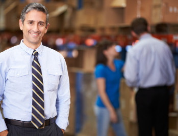 Business owner and operation in a warehouse. Link to retrofit program page.